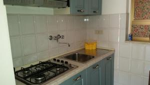 a kitchen with a sink and a stove at Villa Carmelas in Taormina