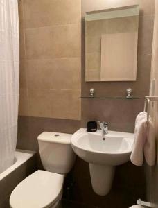 uma casa de banho com um WC branco e um lavatório. em Polis Chrysochous Apartment em Pólis