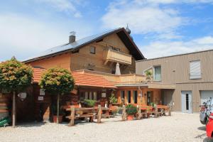 a building with tables and benches in front of it at Hotel-Restaurant Gasthaus Bonimeier in Niedergottsau