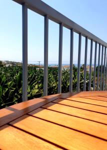 a wooden deck with a view of the ocean at Blue Seaview Appartments in Paphos City