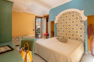 a hotel room with two beds in a room at Hotel Sicilya in San Vito lo Capo