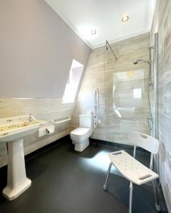 a bathroom with a sink and a toilet and a shower at Dukes Folly Hotel in Southport