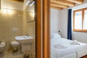 a bathroom with a bed and a sink and a toilet at Residence Garibaldi in Trieste +41 photos