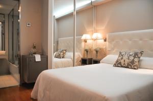Postel nebo postele na pokoji v ubytování Hotel Jucamar