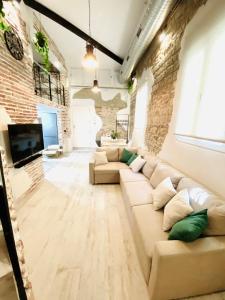 a living room with a couch and a brick wall at Martina´s home in Córdoba