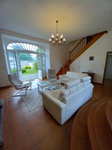 a living room with a couch and a table at l'orangerie in Pontivy