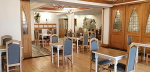 a dining room with wooden tables and chairs at Ivy Tower Hotel in Castlebar