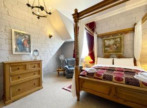 a bedroom with a bed and a dresser in it at Dukes Folly Hotel in Southport