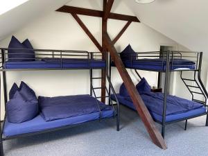 two bunk beds in a room with blue pillows at Villa Schomberg in Spremberg
