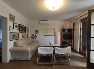 a living room with a couch and a table at Holiday Home Anja in Supetar