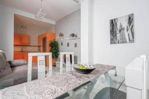 a living room with a table with a bowl of fruit on it at corazon de triana in Seville