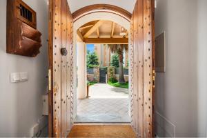 une porte ouverte avec une arche menant à une cour dans l'établissement Villa Playa Felostal, à Palma de Majorque