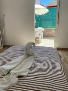 Llit o llits en una habitació de La Casita Alere en Playa Carnota con patio y barbacoa