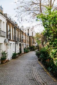 a cobblestone street in a city with buildings at The Vintage - Fitzrovia - by Frankie Says in London