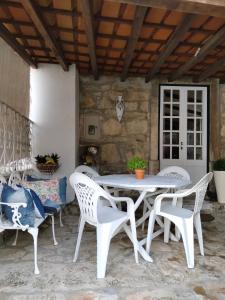 a white table and chairs on a patio at Casa de Chanca in Penela