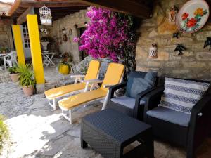 a group of chairs on a patio with flowers at Casa de Chanca in Penela