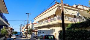 a building with a balcony on the side of a street at Katerina Rodon Apartments in Nea Roda