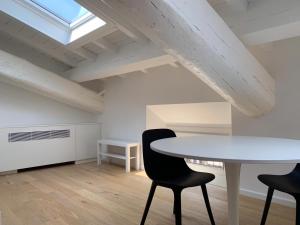 a dining room with a table and two chairs at Residenze Mazzini in Mantova