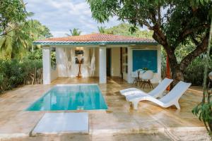 a patio with a pool and chairs and a house at Refugios Parajuru - Casa Manga in Parajuru