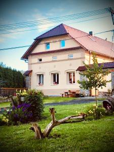 a large white house with a tree branch in the yard at Selská chalupa Anetka in Horšovský Týn