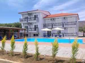 a villa with a swimming pool in a resort at Villa Platanos in Limenaria