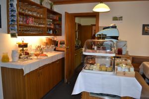 a kitchen with two tables with food on them at Gästehaus-Pension Barbara in Andelsbuch