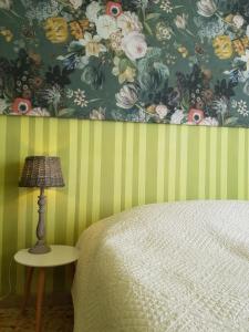 a bedroom with a bed and a table with a lamp at Dimora in San Quirico d'Orcia in San Quirico dʼOrcia