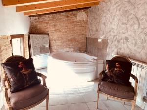 een badkamer met 2 stoelen en een bad bij Castillo-Palacio de Bulbuente in Bulbuente