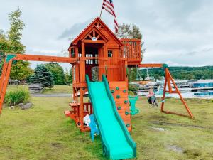 a playground with a slide and a play house at Rangeley Town & Lake in Rangeley