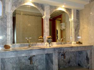 a bathroom with three sinks and a large mirror at Hotel Siviglia in Fiuggi