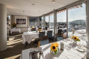 a restaurant with tables and chairs with sunflowers on them at Hotel Roter Turm in Solothurn