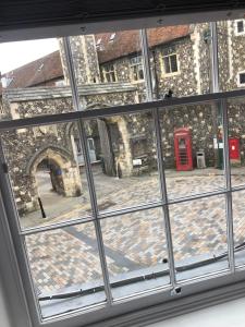 a window view of a building with a red phone booth at The Borough Apartment in Kent