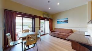 a living room with a couch and a table at Surfside On The Lake in Lake George