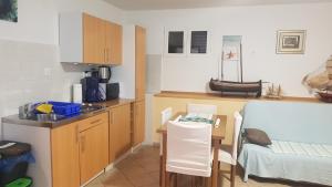 a small kitchen with a table and a counter top at Gita in Omišalj
