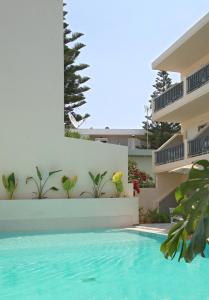 a swimming pool in front of a building at Melitti Hotel in Rethymno Town