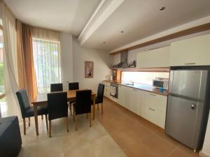 a kitchen and dining room with a table and chairs at Beautiful Sun Village with sea view in Byala