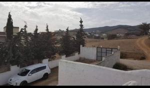 a white car parked in front of a house at Villa Haidra in Dar Merah Deriba