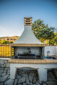 a fireplace sitting on top of a stone patio at VILLA KAROLINA Tsogkas in Syvota