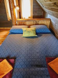 a bedroom with a bed in a cabin at KUNDZINIŠĶI in Leitāni