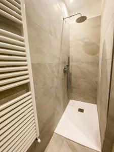 a shower with a glass door in a bathroom at GIALLOMANGO Apt in Lucca in Lucca