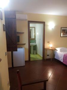 a room with a bed and a room with a mirror at Antico Casale Del Buono in Falconara Albanese