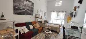 a living room with a couch and a table at Huelintown in Málaga