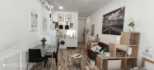 a living room with a table and a living room with at Huelintown in Málaga