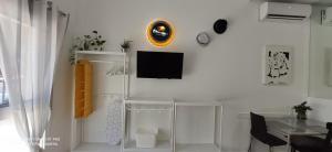 a white living room with a tv on a wall at Huelintown in Málaga