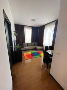 a living room with a couch and a table with a colorful rug at ANK Summerland Mamaia in Mamaia