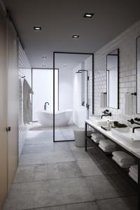 a bathroom with two sinks and a bath tub at FULTON Business Luxury HOTEL in Guadalajara