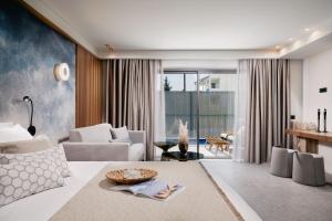 a living room with a couch and a table at Origami Boutique Residences in Nafplio +54 photos