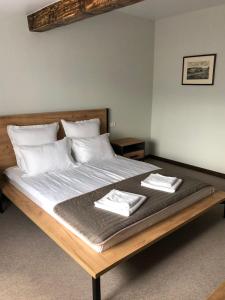 a large bed with two towels on top of it at HUSTON in Khust