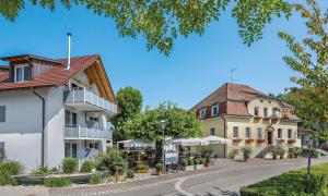 a street in a town with buildings and trees at Gasthaus Schiff in Moos