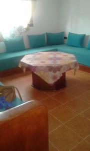 a living room with a couch and a table at Villa Haidra in Dar Merah Deriba
